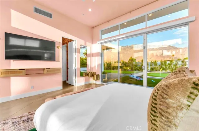 a patio with a table and chairs and potted plants