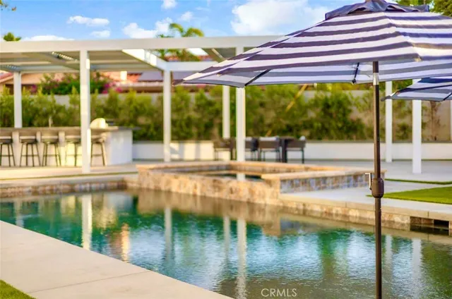 a view of a patio with table and chairs and potted plants