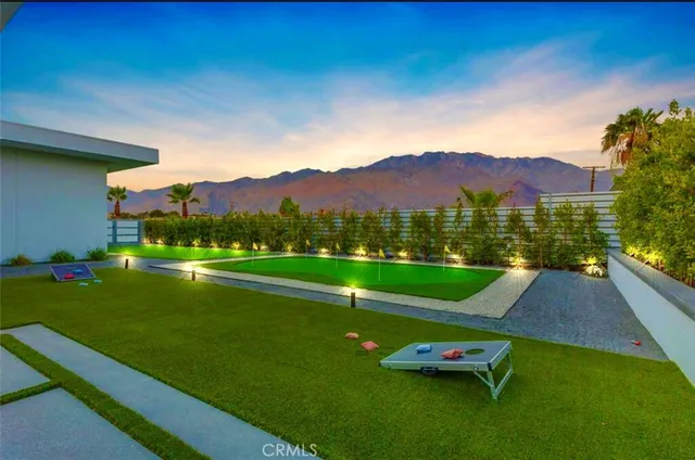 a view of a living room with furniture and floor to ceiling window