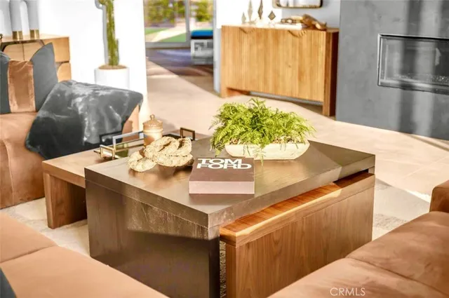 a living room with furniture chandelier and a large window