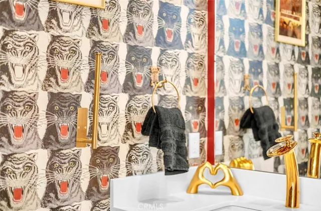 a living room with furniture kitchen view and a chandelier