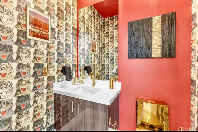 a living room with furniture kitchen view and large windows