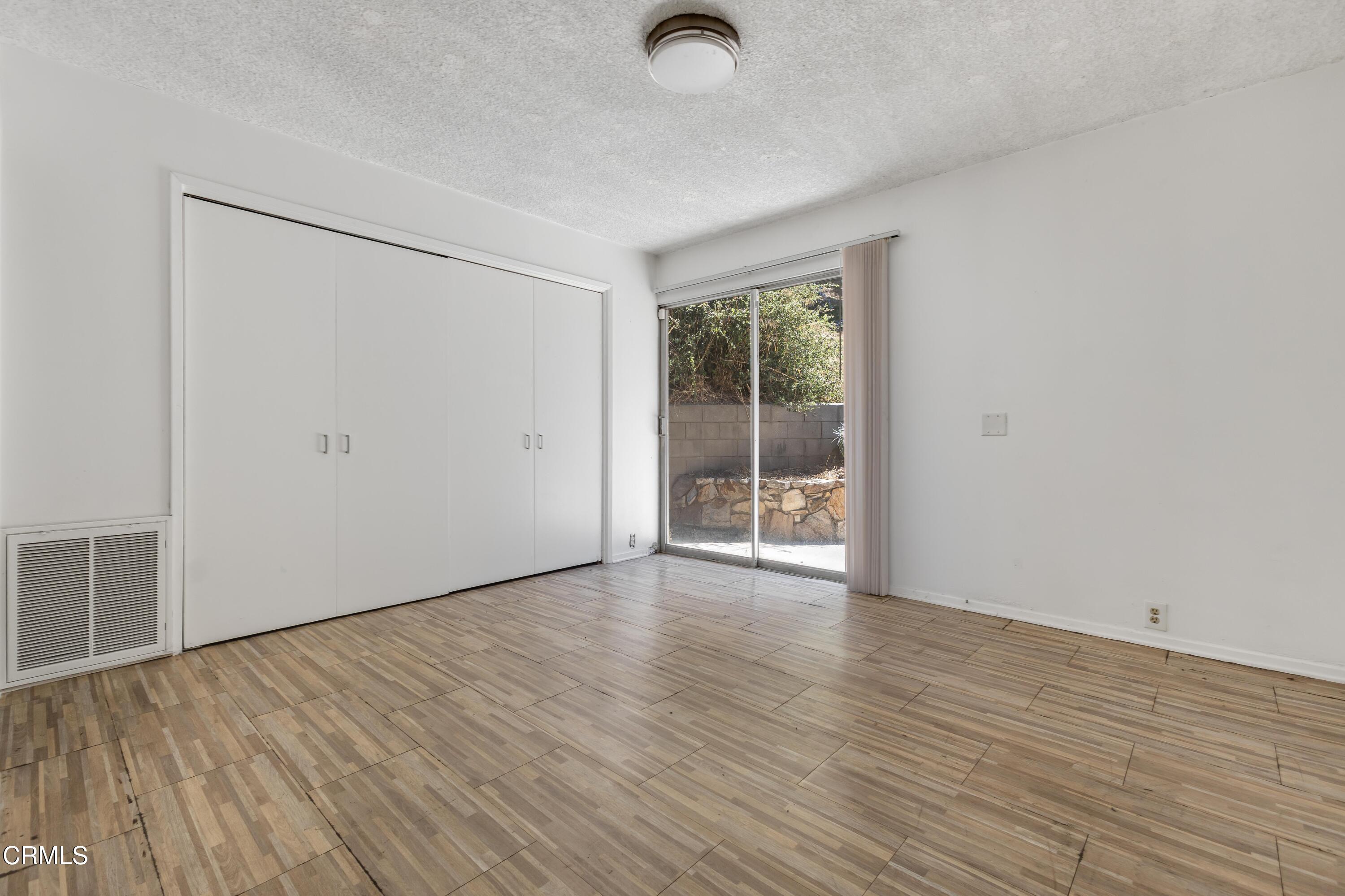 16274 Dorilee Lane Encino, CA 91436 - Photo 13 of 23 an empty room with wooden floor and windows