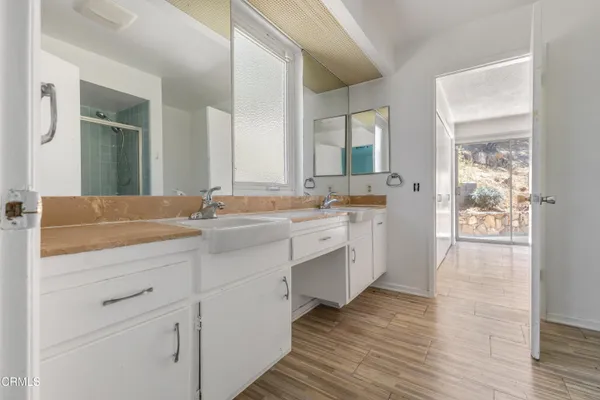 a spacious bathroom with a double vanity sink and mirror