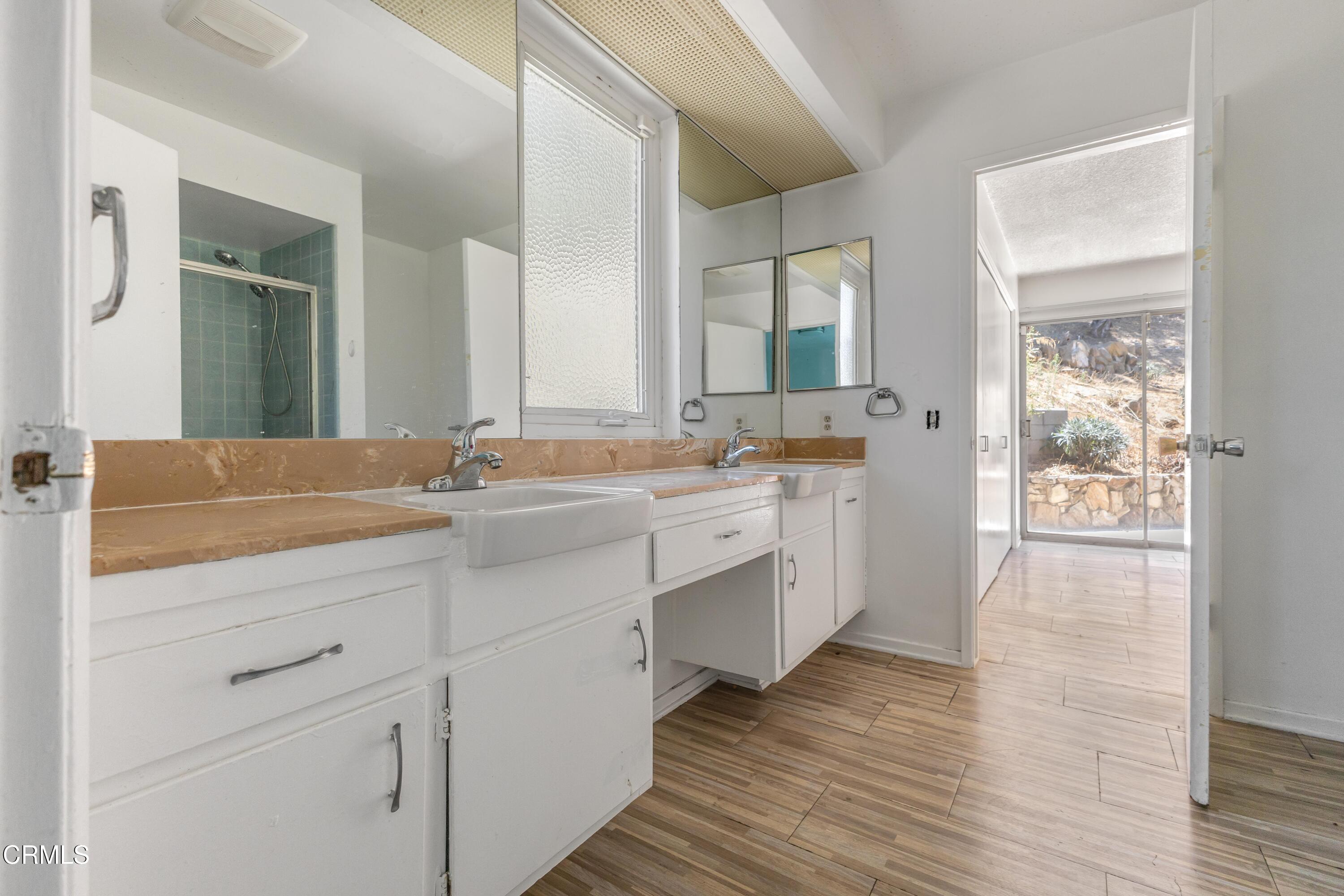 16274 Dorilee Lane Encino, CA 91436 - Photo 14 of 23 a spacious bathroom with a double vanity sink and mirror