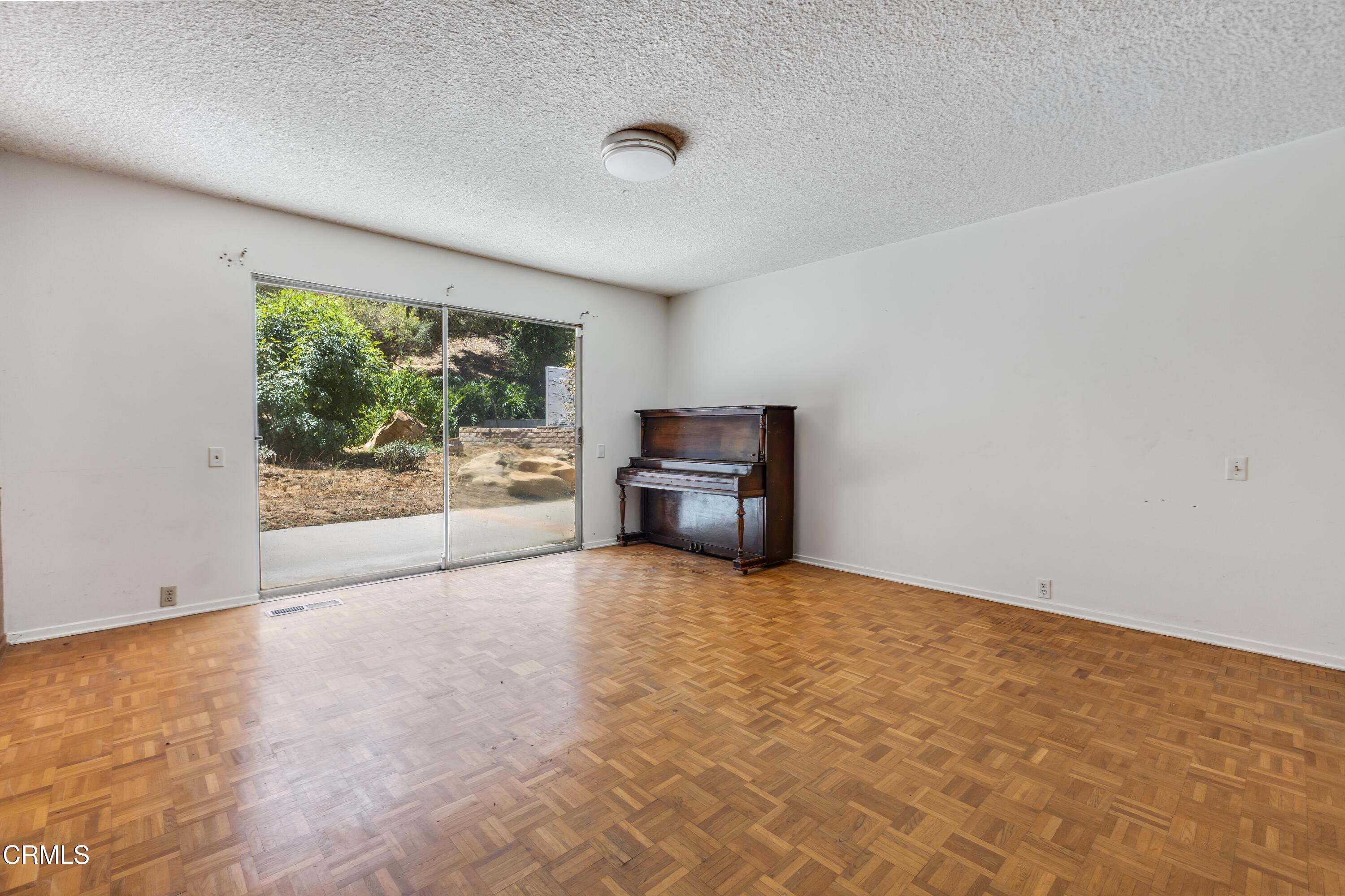 16274 Dorilee Lane Encino, CA 91436 - Photo 16 of 23 an empty room with floor to ceiling window and an outdoor view
