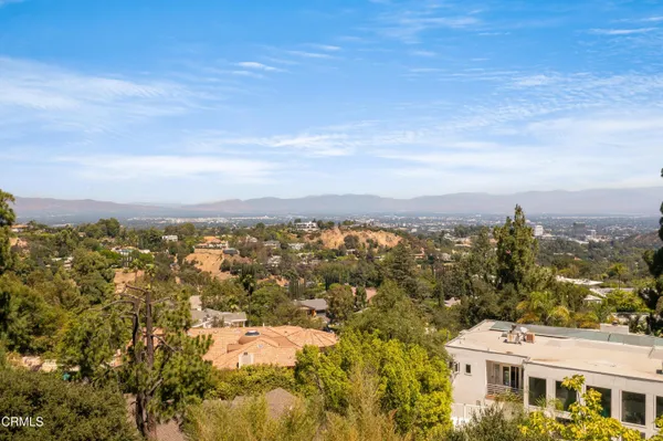 an aerial view of residential houses with city view