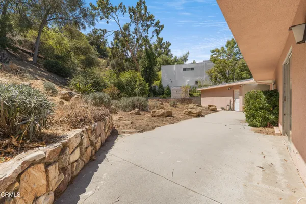 a pathway of a house with a yard