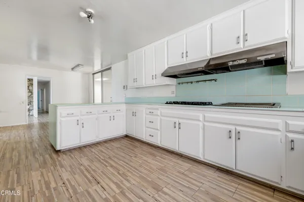 a kitchen with stainless steel appliances granite countertop white cabinets and a granite counter tops