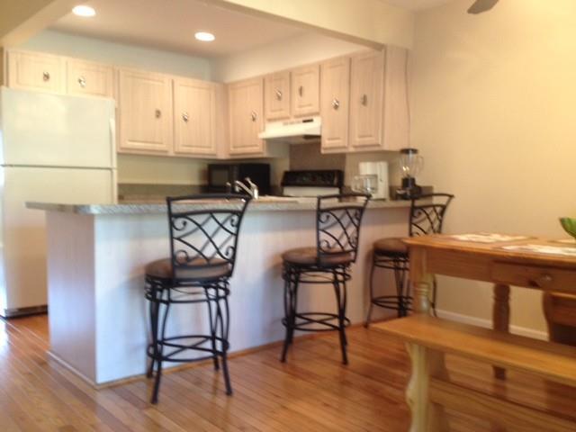 a view of kitchen with cabinets and wooden floor