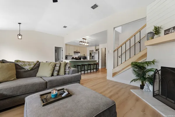 a living room with furniture and a potted plant