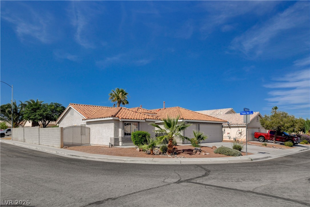 910 Cobblestone Cove Road North Las Vegas, NV 89081 - Photo 2 of 30 A well-maintained desert landscape frames this welcoming residence on a corner lot.