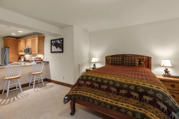 a bedroom with a bed and a table in it