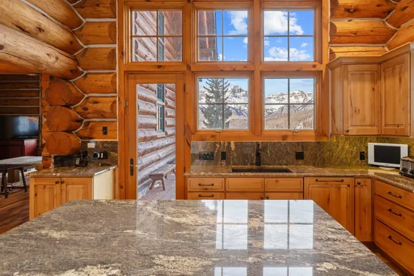 a view of a kitchen with a sink and cabinets