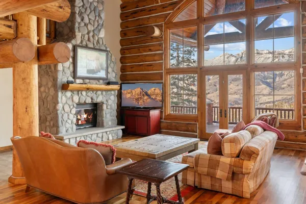a living room with furniture a fireplace and windows