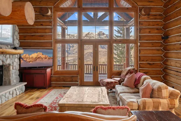 a living room with furniture and a floor to ceiling window