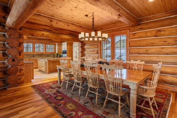 a view of a dining room with furniture and chandelier