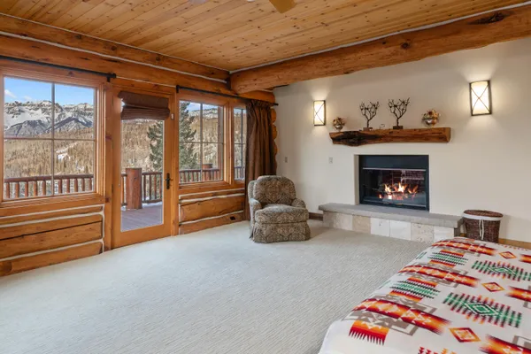 a bedroom with a bed and a fireplace