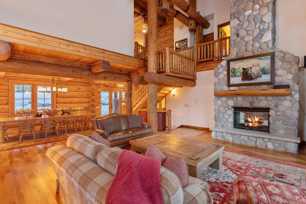 a living room with furniture a rug and a fireplace