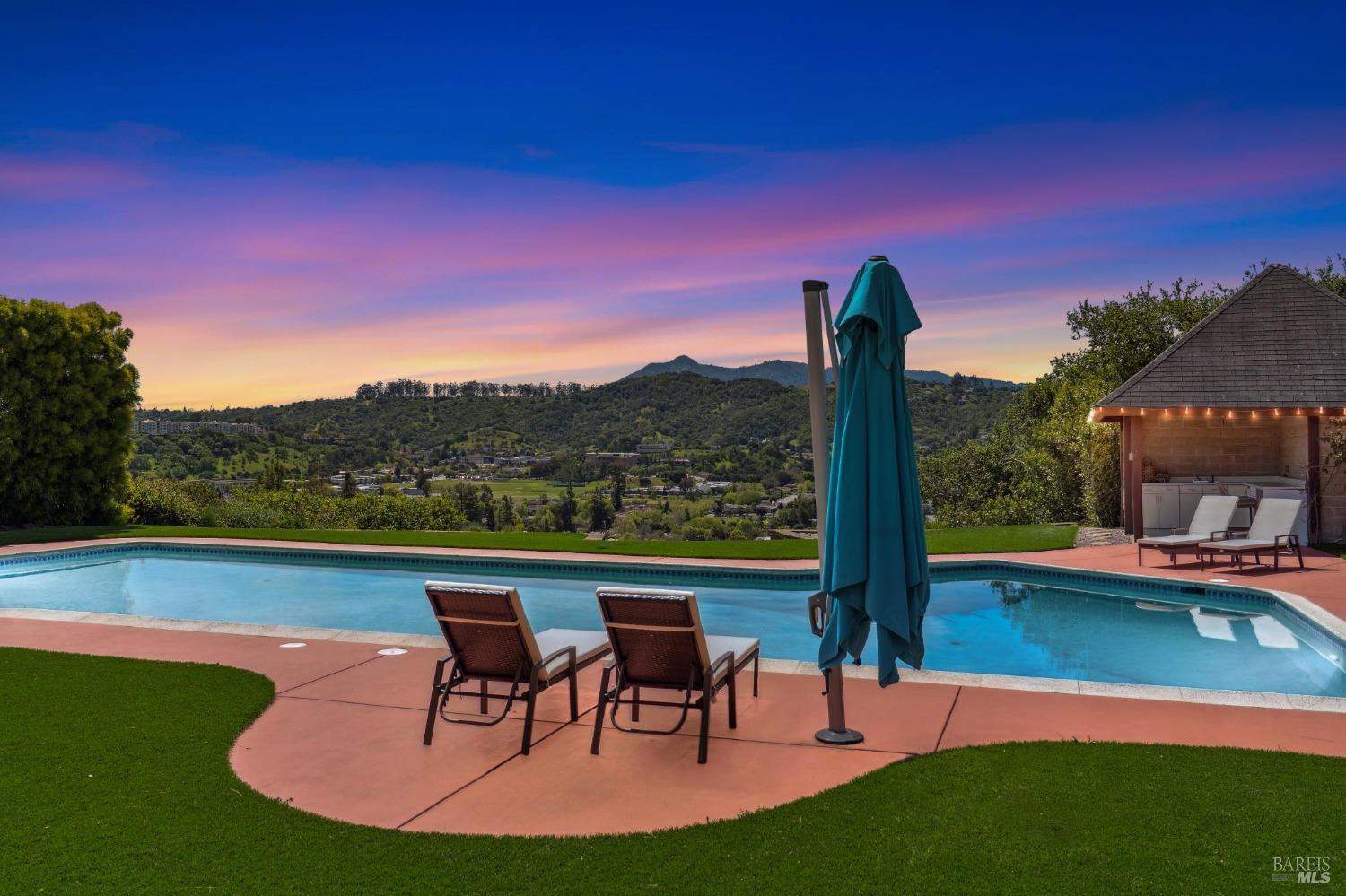 a view of a lake with a table and chairs