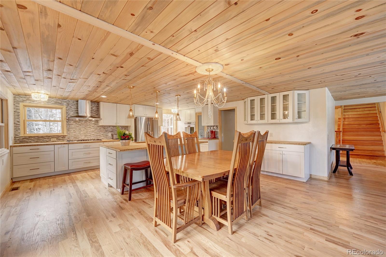 526 Rising Sun Road Bailey, CO 80421 - Photo 15 of 40 a view of a dining room with furniture and wooden floor