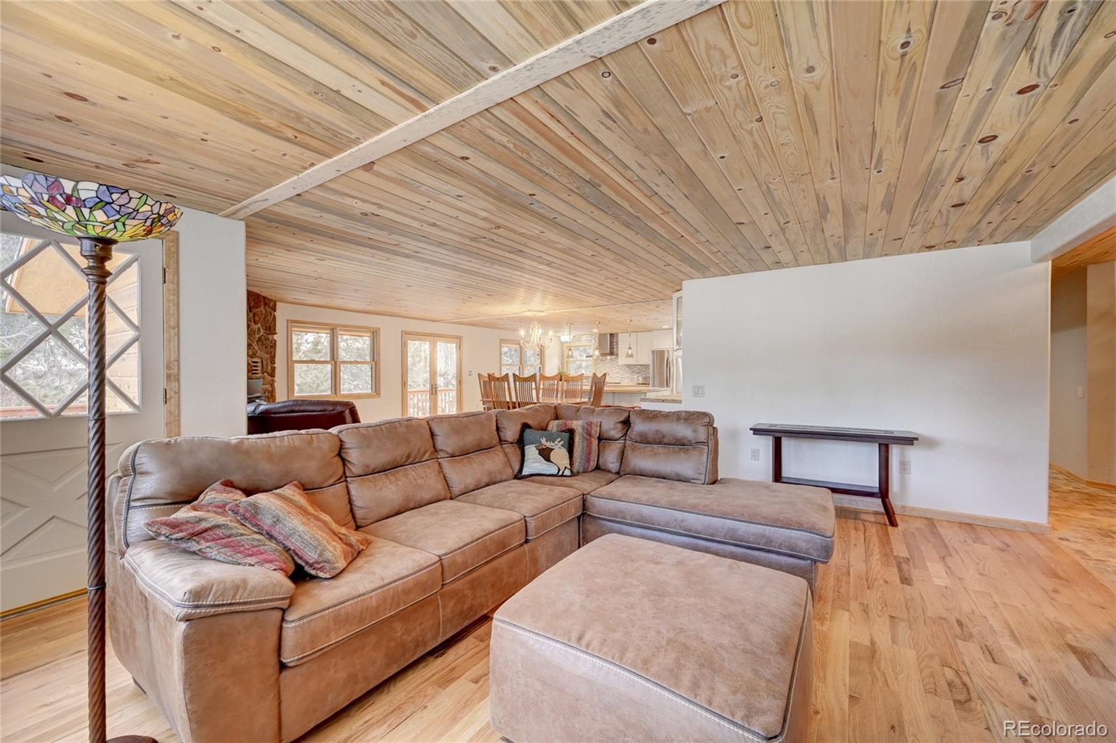 526 Rising Sun Road Bailey, CO 80421 - Photo 19 of 40 a living room with furniture and a wooden floor