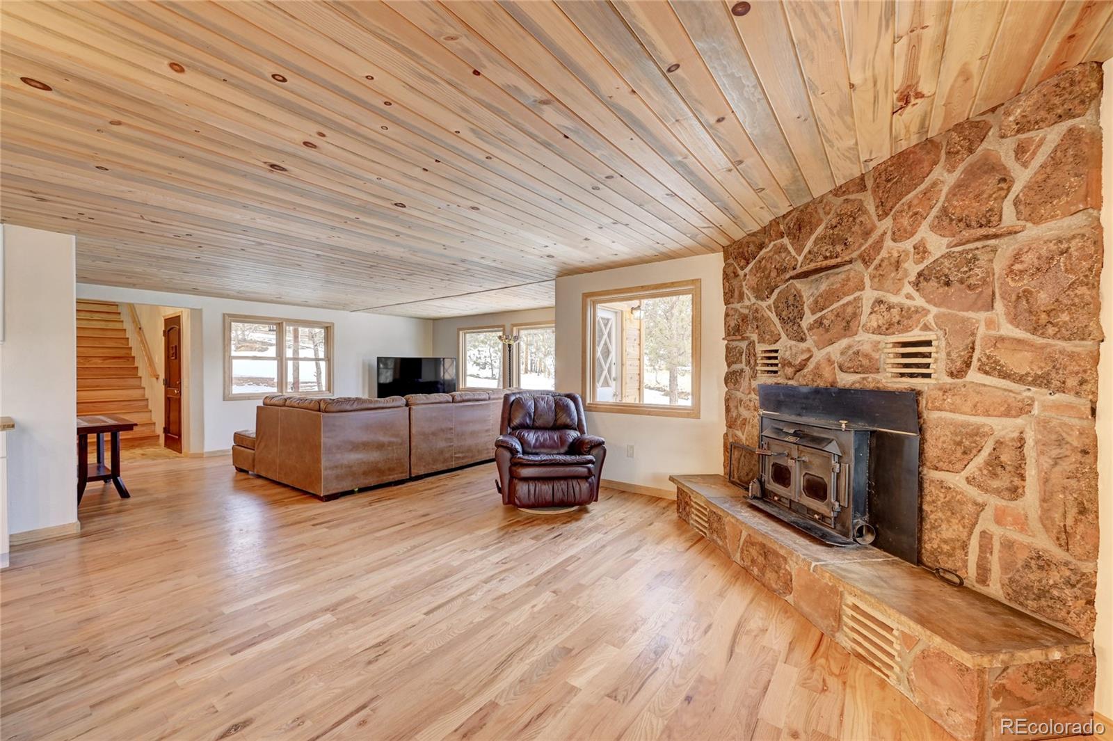 526 Rising Sun Road Bailey, CO 80421 - Photo 21 of 40 a living room with furniture and a fireplace