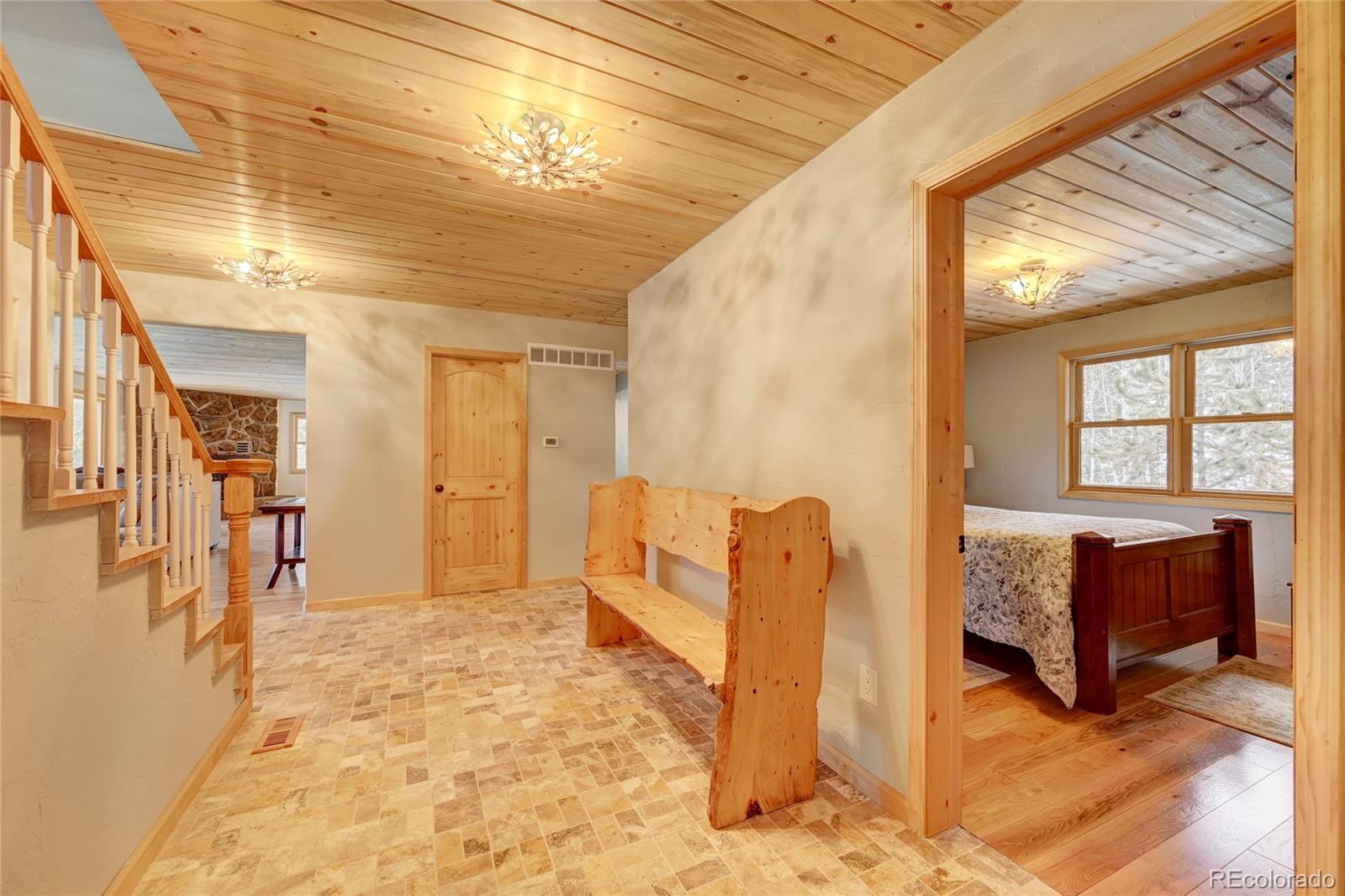 526 Rising Sun Road Bailey, CO 80421 - Photo 26 of 40 a spacious bedroom with a bed and a couch