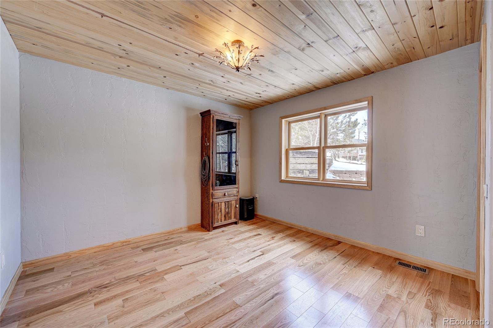 526 Rising Sun Road Bailey, CO 80421 - Photo 28 of 40 a view of empty room with wooden floor and fan
