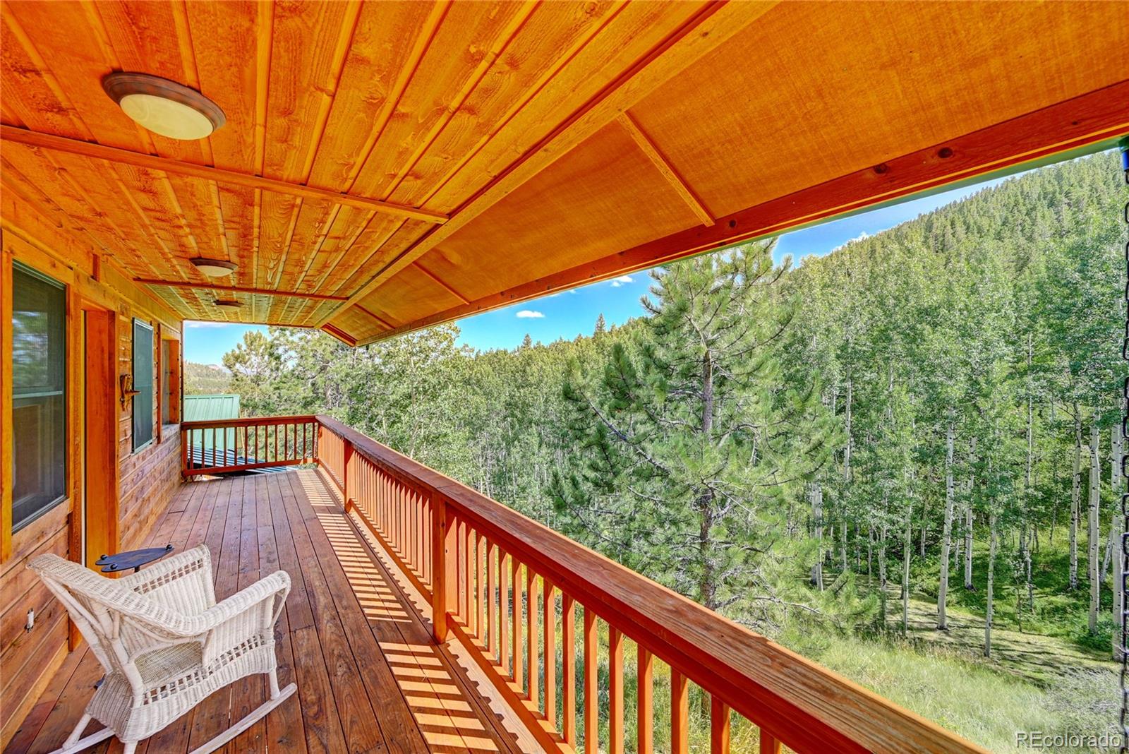 526 Rising Sun Road Bailey, CO 80421 - Photo 8 of 40 a view of a balcony with chairs
