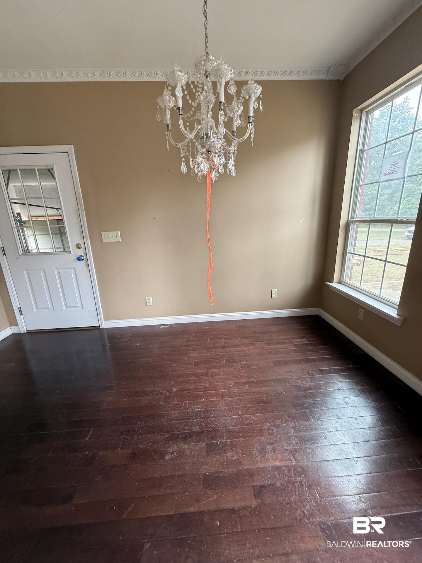 99 Cemetery Street Uriah, AL 36480 - Photo 9 of 13 Unfurnished dining area featuring dark wood-style floors and suspended lighting