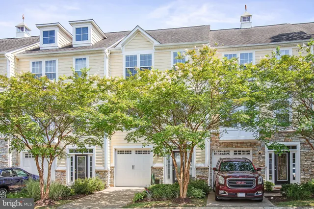 a front view of a residential apartment building with a yard