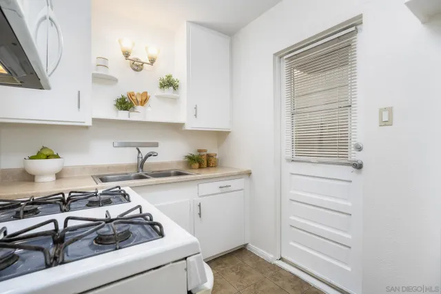 a kitchen with a sink stove and cabinets