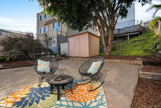 a view of a chairs and table in backyard