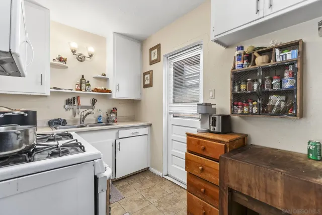 a kitchen with stainless steel appliances granite countertop a stove and a refrigerator