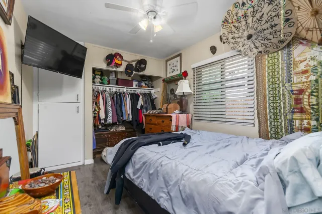 a bed room with a bed and a flat screen tv