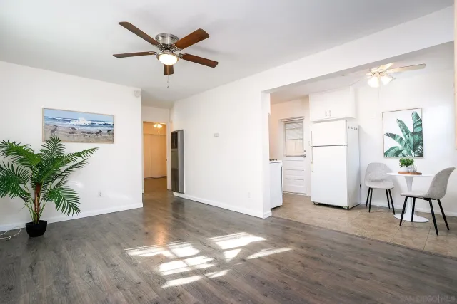 a living room with furniture and a table with wooden floor