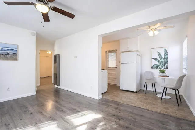 a view of a livingroom with a window and wooden floor