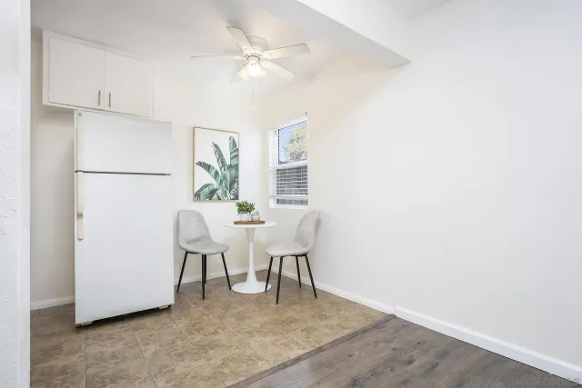 a view of a dining room with furniture and a chandelier