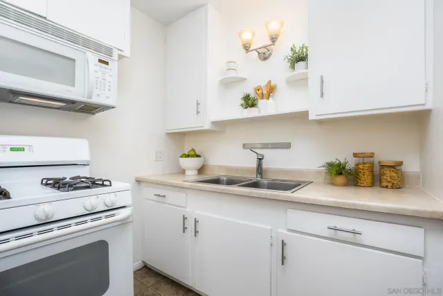 a kitchen with stainless steel appliances white cabinets and a stove