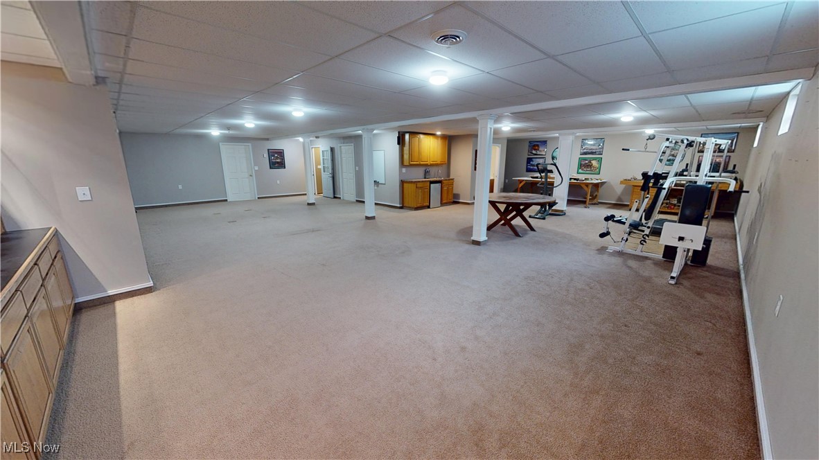 10323 Smith Road Litchfield, OH 44253 - Photo 35 of 50 Exercise room featuring decorative columns, a paneled ceiling, baseboards, and visible vents