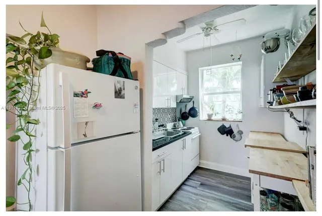 a white refrigerator freezer sitting inside of a kitchen