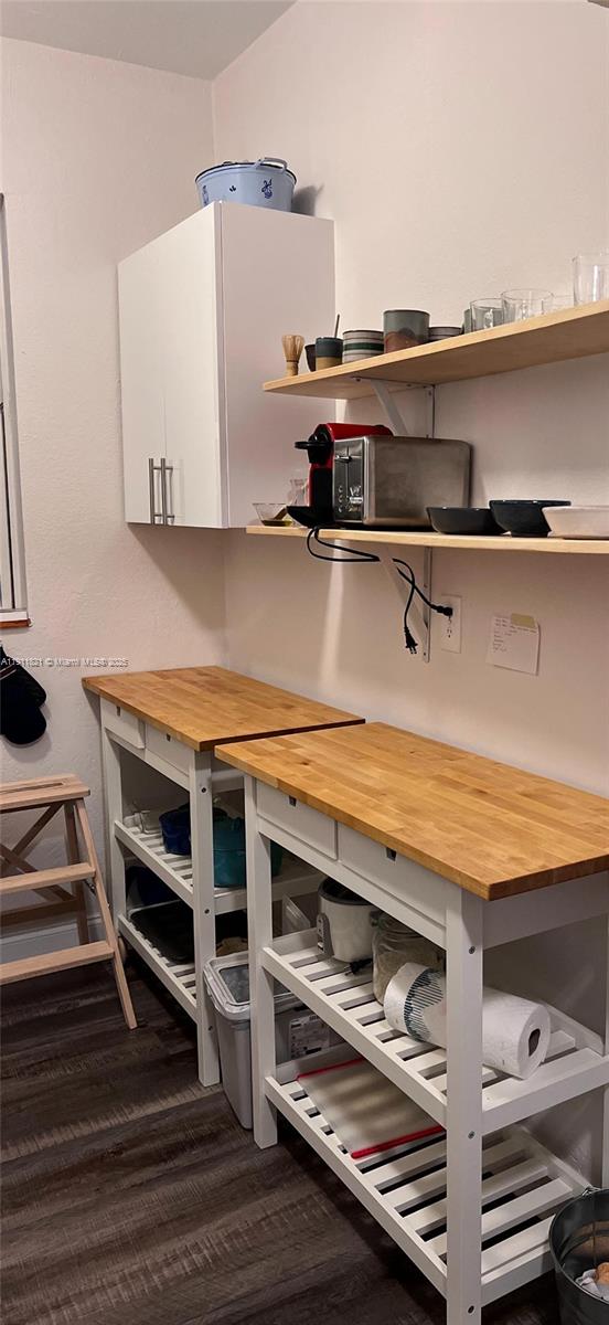 320 80th Street, Unit 15 Miami Beach, FL 33141 - Photo 5 of 6 a view of kitchen with wooden floor and cabinets