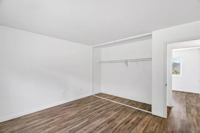 an empty room with wooden floor