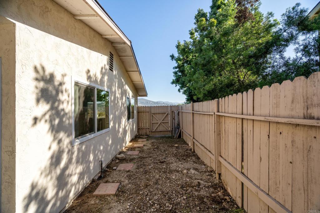 2964 Crane Street, Unit A B Lemon Grove, CA 91945 - Photo 19 of 50 a view of a pathway of a building with wooden fence