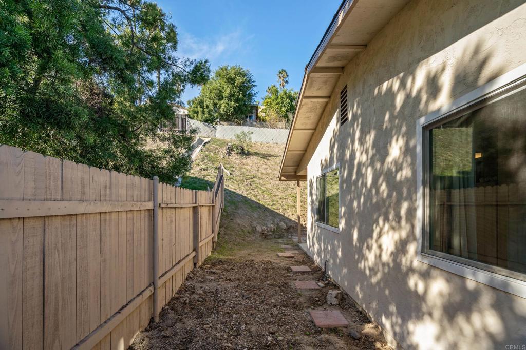 2964 Crane Street, Unit A B Lemon Grove, CA 91945 - Photo 20 of 50 a view of a pathway of a house with wooden fence