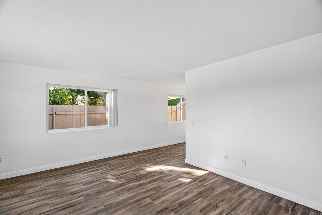 2964 Crane Street, Unit A B Lemon Grove, CA 91945 - Photo 2 of 50 a view of an empty room with wooden floor and a window