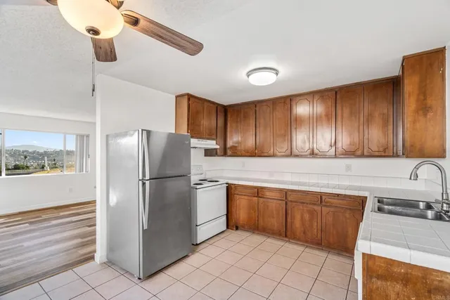 a kitchen with a refrigerator a sink and cabinets
