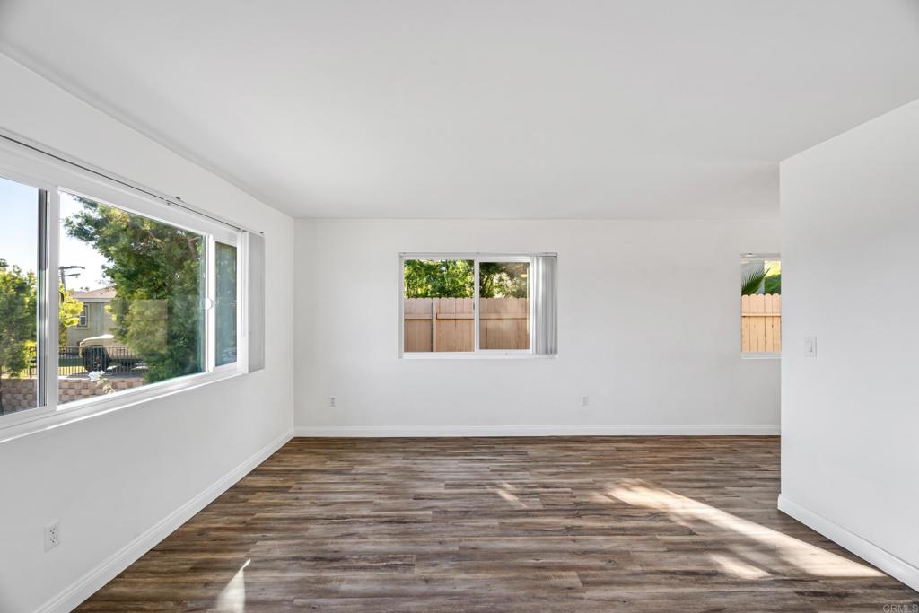 2964 Crane Street, Unit A B Lemon Grove, CA 91945 - Photo 3 of 50 a view of an empty room with wooden floor and a window
