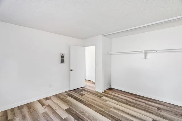 a view of a room with wooden floor